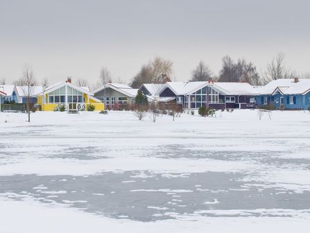 Das Bild zeigt einen Teil des Südsees mit Ferienhäusern im Hintergrund.